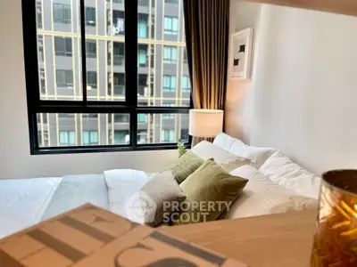 Modern bedroom with large window and stylish decor in urban apartment