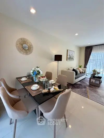 Elegant living and dining area with modern decor and natural light