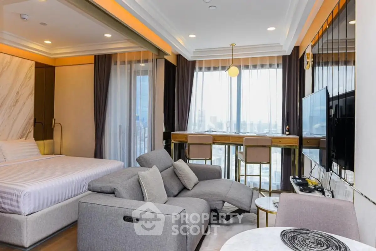 Luxurious modern studio with panoramic city views and elegant furnishings