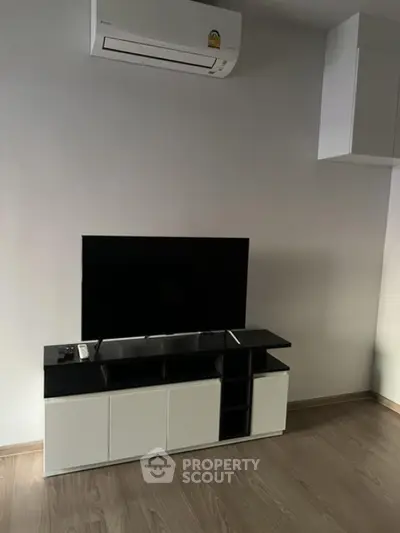 Modern living room with sleek TV stand and air conditioning unit