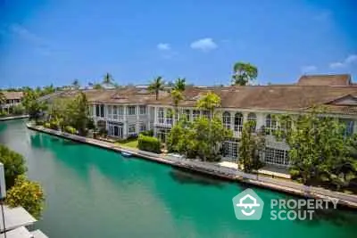 Stunning waterfront villas with lush greenery and serene canal view