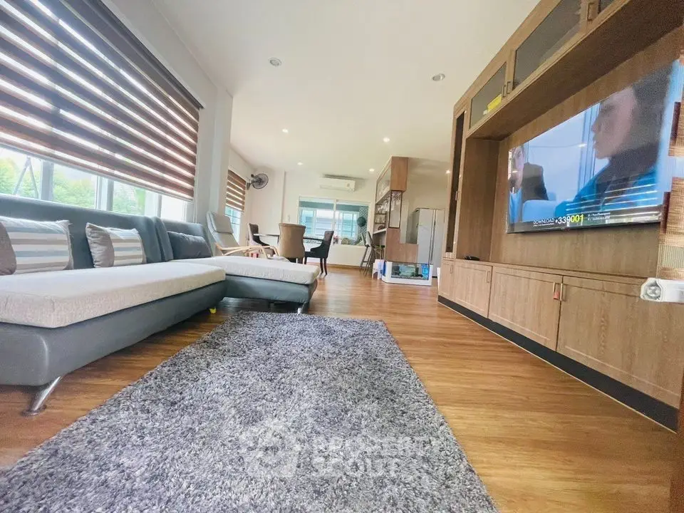 Spacious living room with modern decor and large windows for natural light