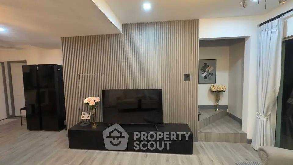 Modern living room with sleek TV unit and elegant decor