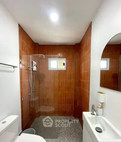 Modern bathroom with sleek shower and stylish red tiles
