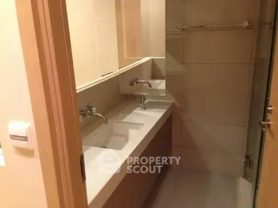 Modern bathroom with dual sinks and sleek design in a contemporary apartment.