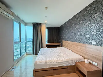 Modern bedroom with city view, featuring stylish wallpaper and large windows for natural light.