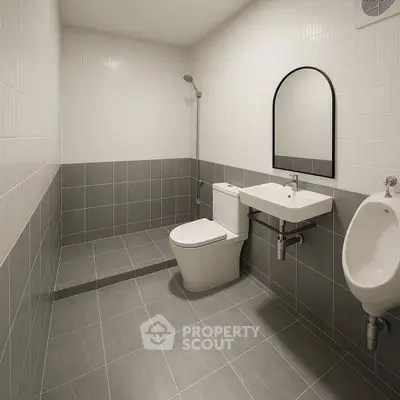 Modern minimalist bathroom with sleek gray tiles and white fixtures