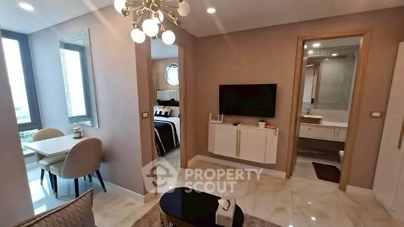 Modern apartment interior with stylish living room, dining area, and bedroom view.