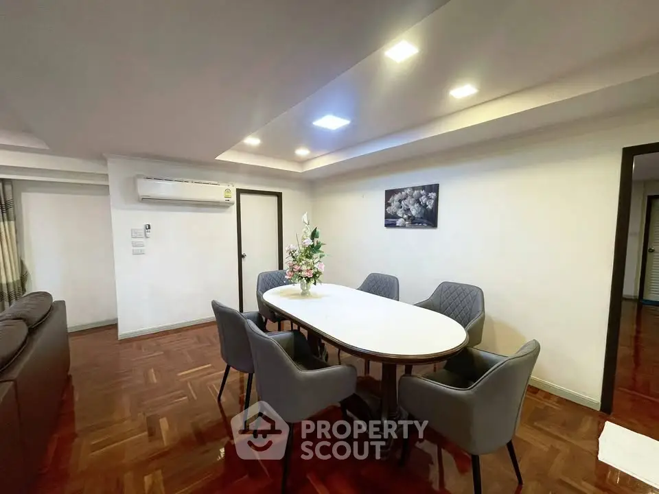 Elegant dining area with modern furniture and stylish lighting in a spacious living room.