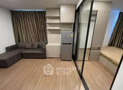 Modern studio apartment with sleek design, featuring a cozy living area and compact kitchen space.
