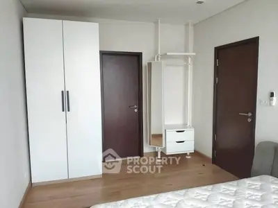 Modern bedroom with sleek wardrobe and minimalist design