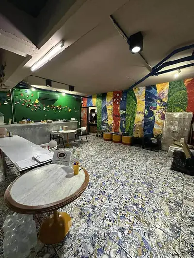 Vibrant interior space with colorful wall art and decorative flooring, ideal for creative activities.