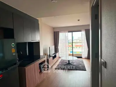 Modern living room with sleek kitchen and city view balcony in urban apartment.