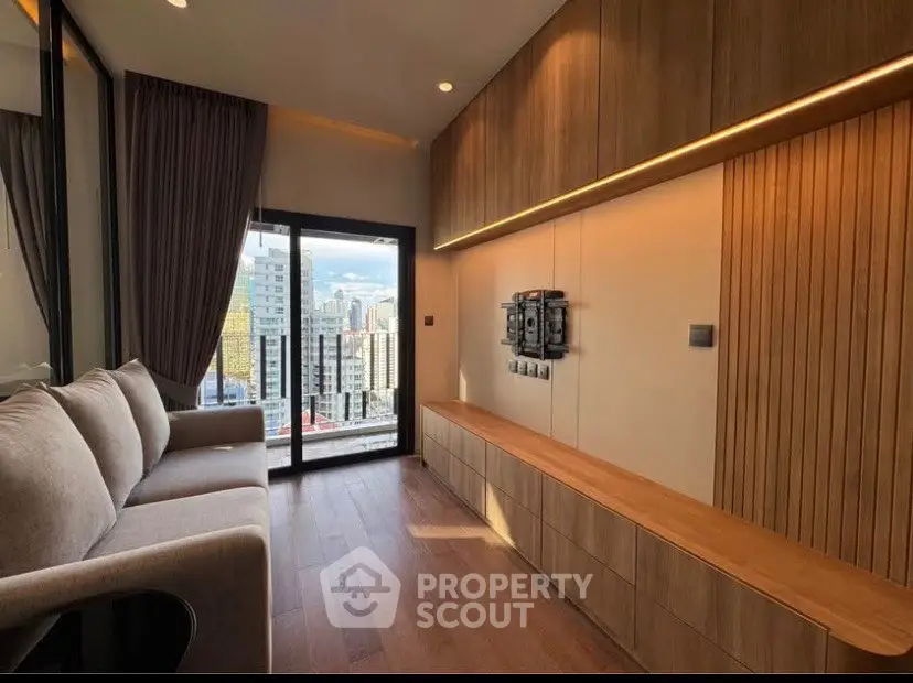 Modern living room with large window and city view, featuring sleek wooden paneling and cozy sofa.