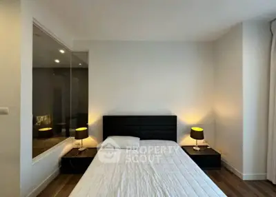 Modern bedroom with sleek design and ambient lighting, featuring a comfortable bed and stylish nightstands.