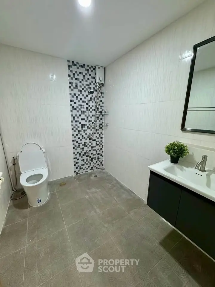 Modern bathroom with sleek fixtures and stylish tile design, perfect for contemporary living.