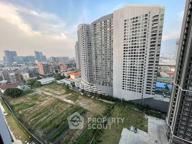 Stunning cityscape view from high-rise building showcasing urban skyline and green spaces.