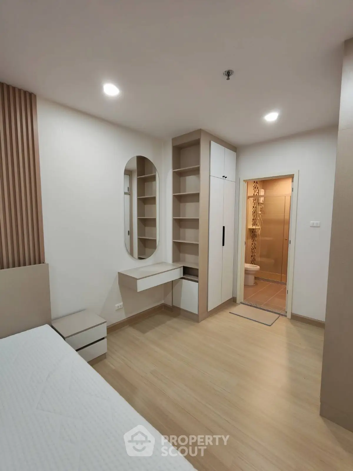 Modern bedroom with built-in storage and ensuite bathroom