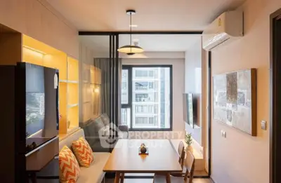 Modern living room with dining area, large window, and stylish decor in a contemporary apartment.