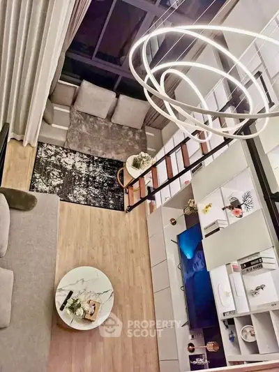 Modern loft living room with stylish decor and unique lighting fixture