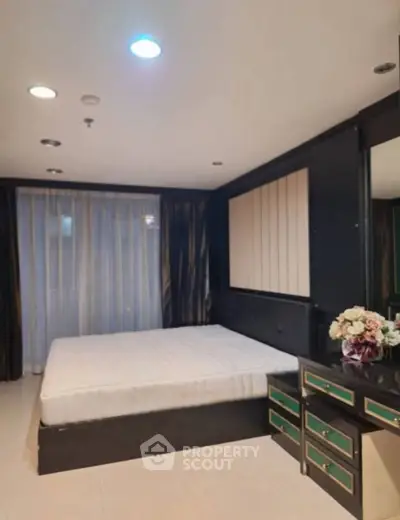 Luxurious bedroom with elegant decor and ample natural light, perfect for relaxation and comfort.