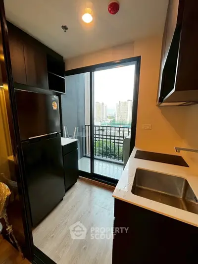 Modern kitchen with balcony view in urban apartment