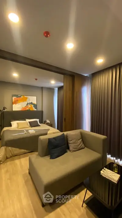 Modern bedroom with cozy seating area and stylish decor