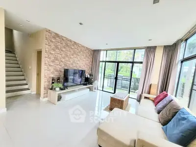 Spacious living room with modern decor and large windows for natural light