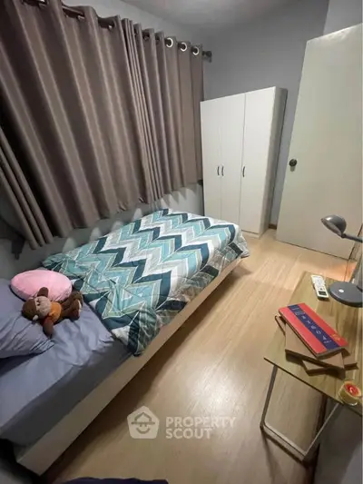 Cozy bedroom with modern decor and ample natural light