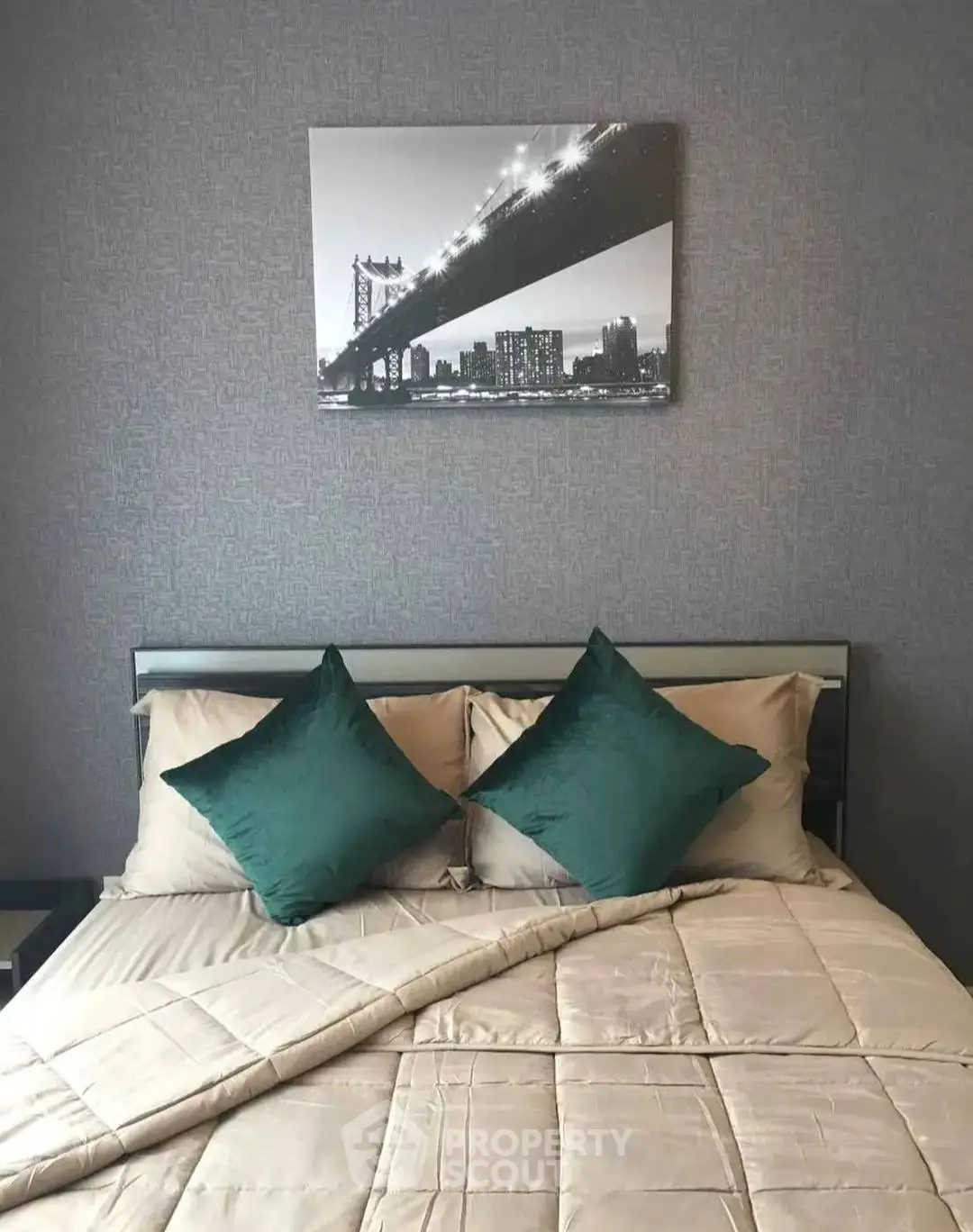 Cozy bedroom with stylish decor and elegant bedding, featuring a modern art piece above the bed.