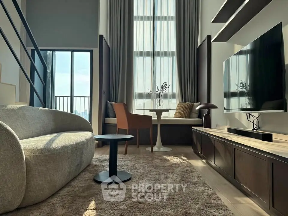 Modern living room with high ceilings, large windows, and stylish furniture in a luxurious apartment.