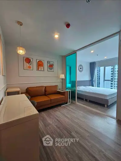 Modern apartment interior with stylish living room and cozy bedroom, featuring elegant decor and natural light.