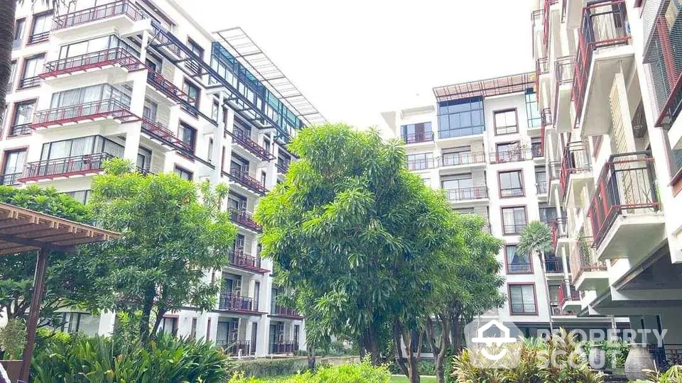 Modern apartment building with lush garden and spacious balconies