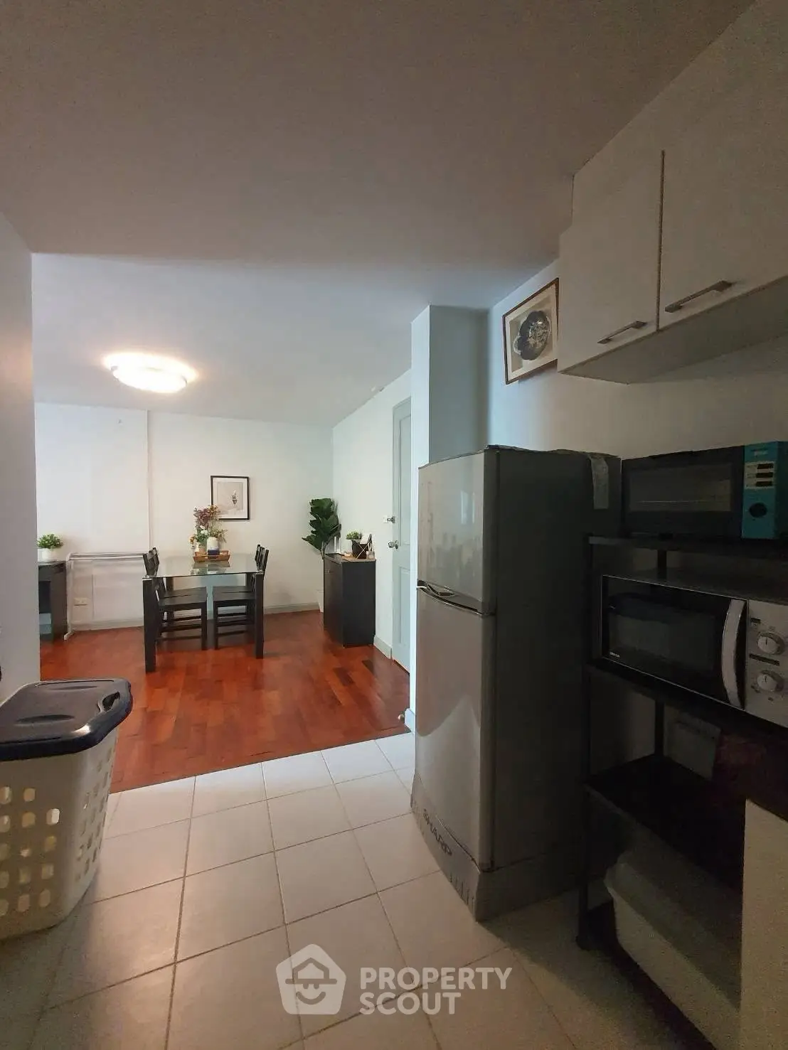 Cozy kitchen with dining area and modern appliances in a stylish apartment.