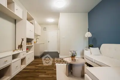 Modern living room with stylish furniture and open layout, featuring a cozy sofa and elegant decor.
