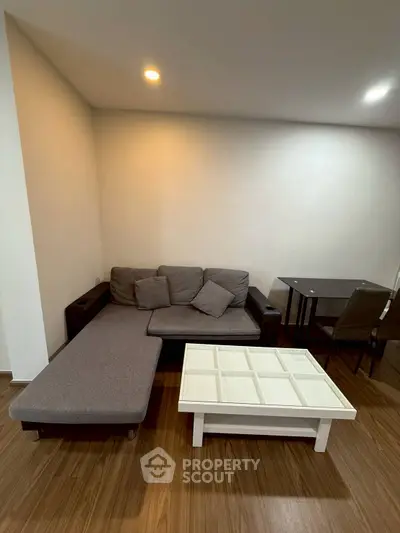Modern living room with cozy gray sofa and stylish coffee table