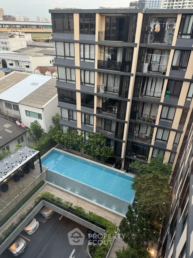 Modern condominium with pool view and cityscape in urban setting