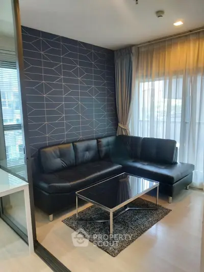 Modern living room with stylish geometric wallpaper and sleek black leather sofa