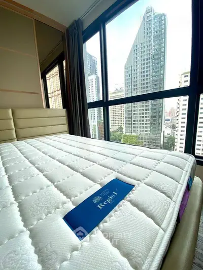 Spacious bedroom with city view in modern high-rise apartment