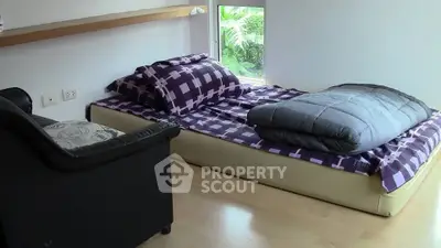 Cozy bedroom with modern decor and natural light, featuring a comfortable bed and stylish furnishings.