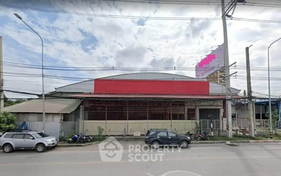 Spacious commercial warehouse with ample parking and street access, ideal for business operations.