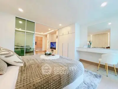Modern bedroom with stylish decor and sliding glass doors leading to a spacious living area.