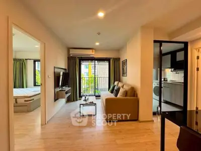 Modern living room with open layout and balcony view in stylish apartment.