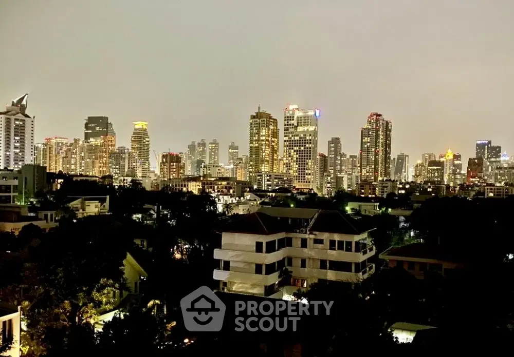 Stunning city skyline view from a high-rise apartment balcony at dusk, showcasing urban living.
