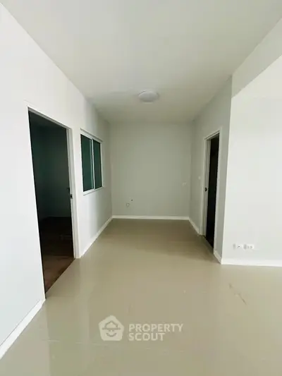 Spacious empty hallway in modern apartment with tiled flooring