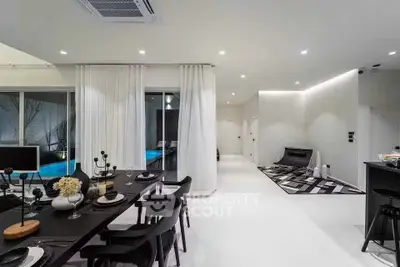 Modern open-plan living room with sleek dining area and pool view, perfect for luxury living.