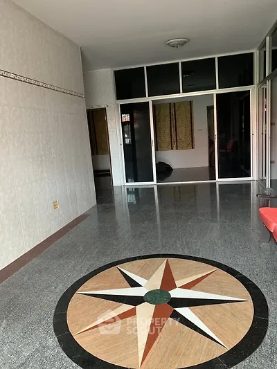 Spacious interior with unique floor design and sliding glass doors, perfect for modern living.
