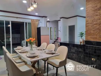 Elegant dining area with modern decor and open kitchen layout