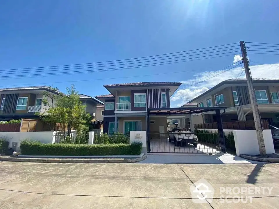 Modern two-story house with driveway and carport in a sunny suburban neighborhood.