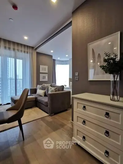 Stylish modern living room with elegant decor and large windows in a high-rise apartment.